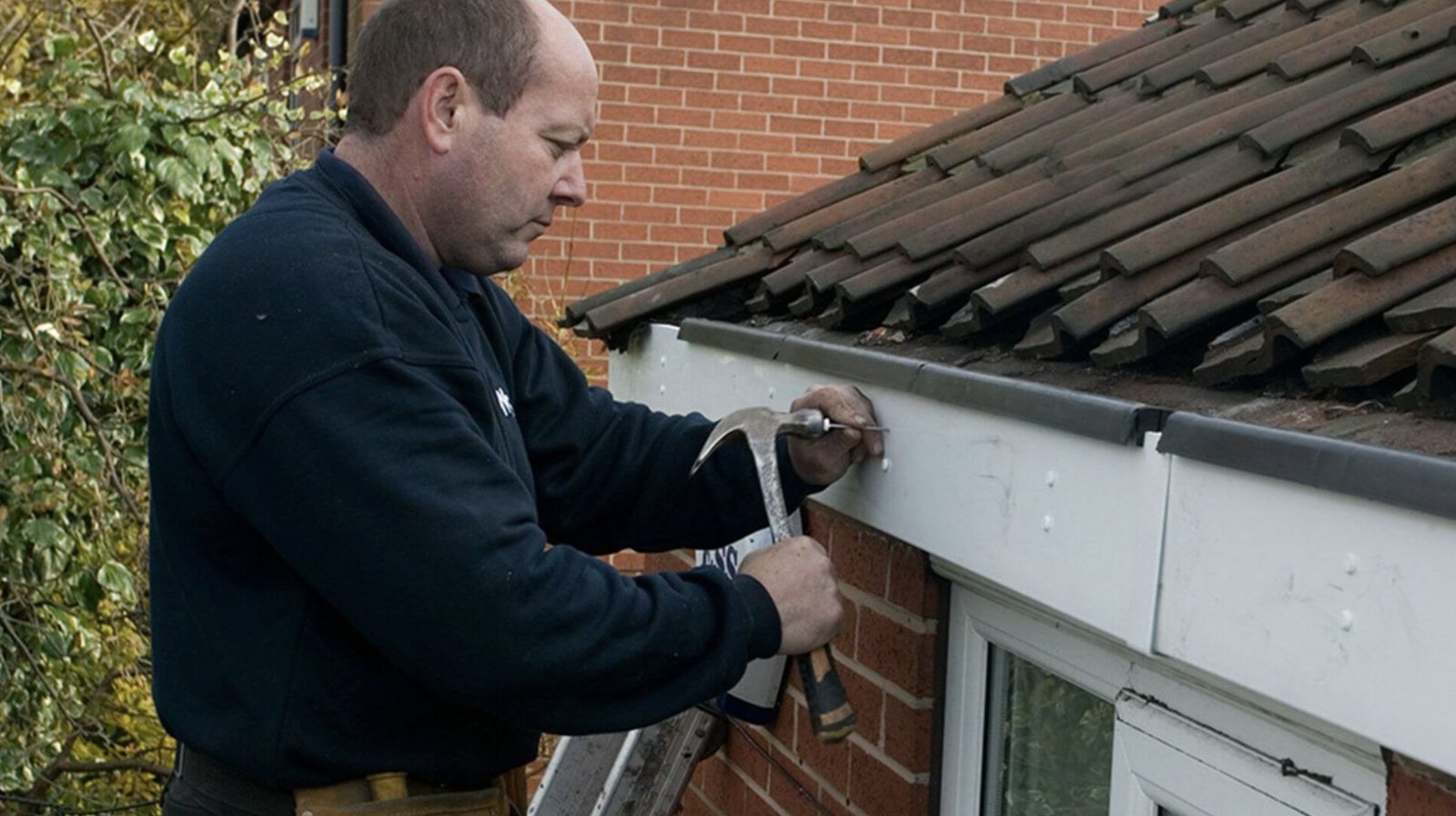 Fitter replacing fascia boards