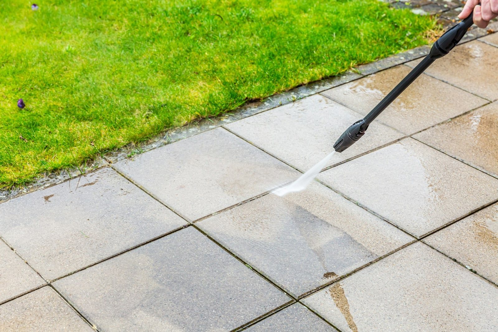 Pressure washer lance cleaning patio slabs