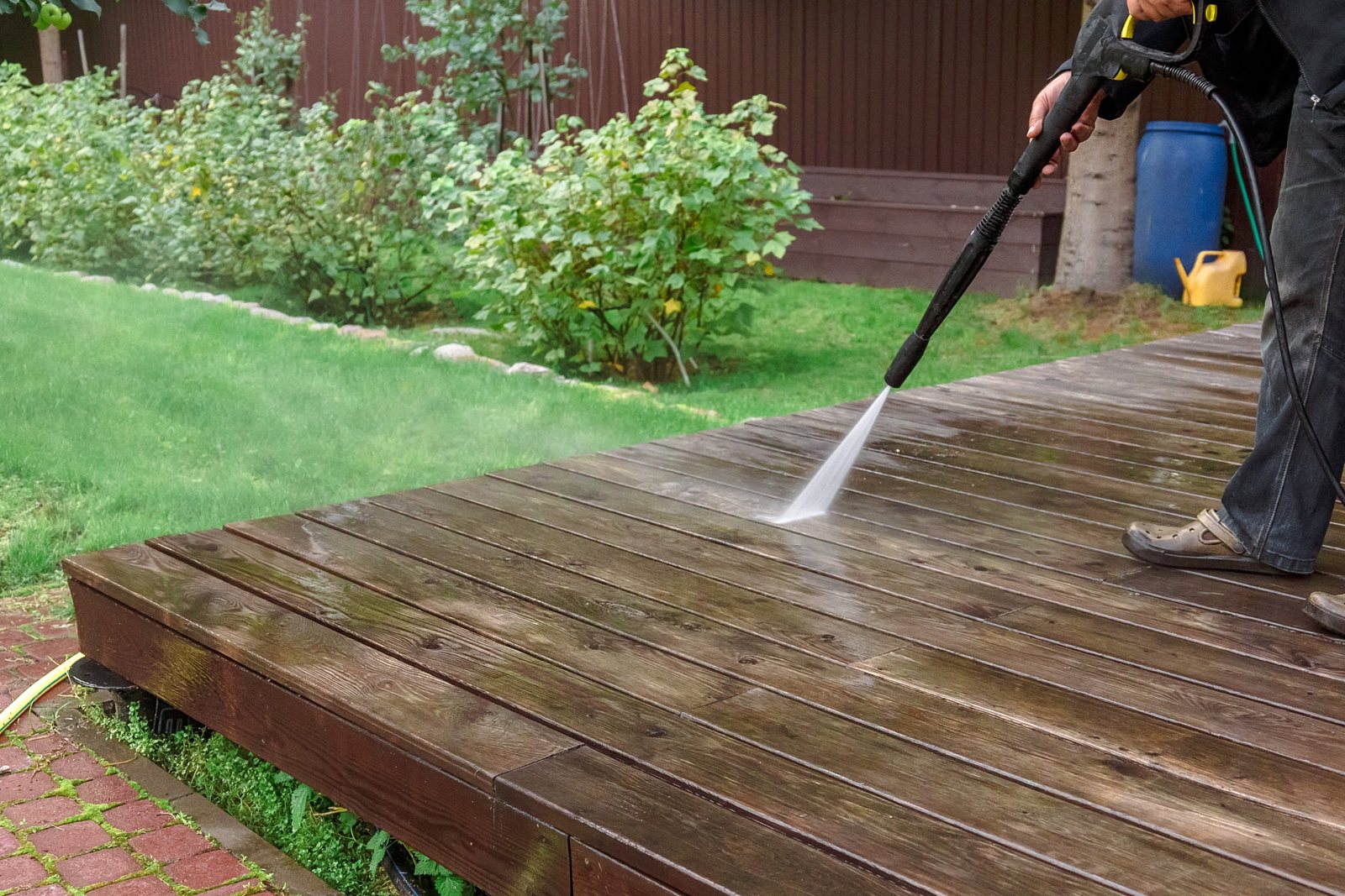Garden decking being pressure washed