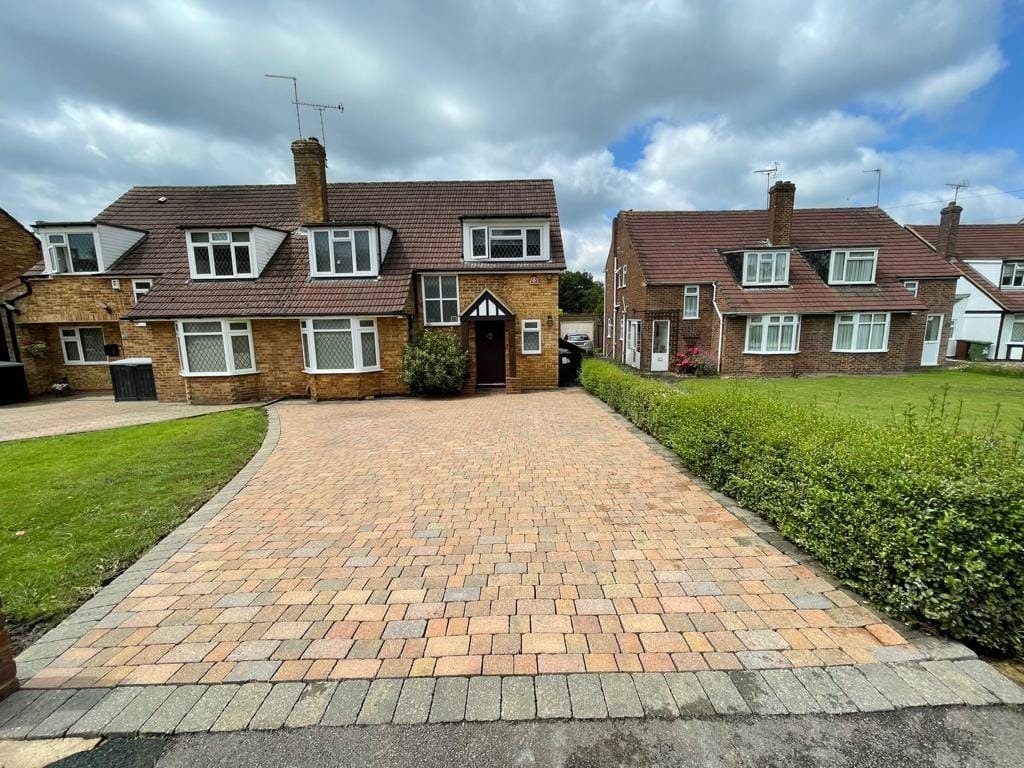 Freshly cleaned block-paved driveway in front of UK houses