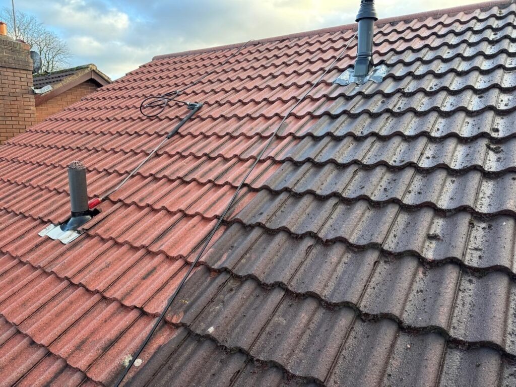 Roof half cleaned showing clean and dirty tiles